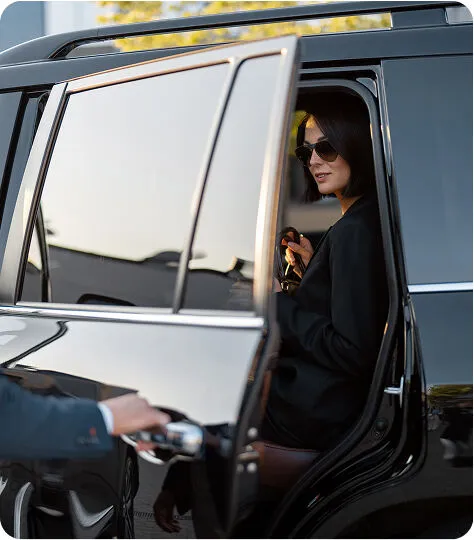 Chauffeur opening luxury SUV door for executive client in Colorado
