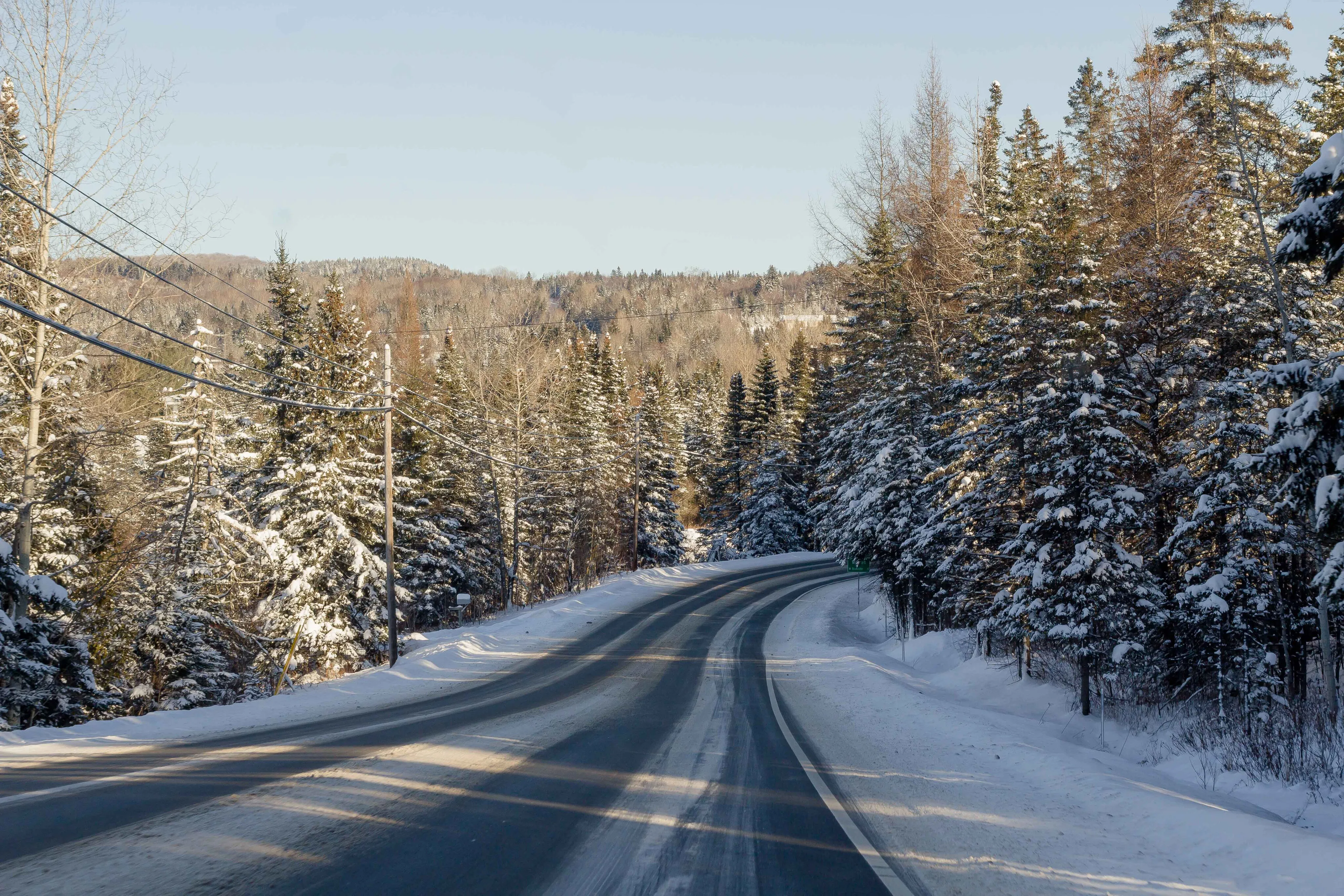 Winter road through snow-covered forest in the Colorado mountains near Aspen and Vail