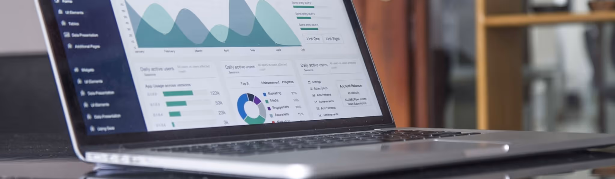 A young woman working in a machine shop. She is looking directly towards the camera, and is surrounded by men.