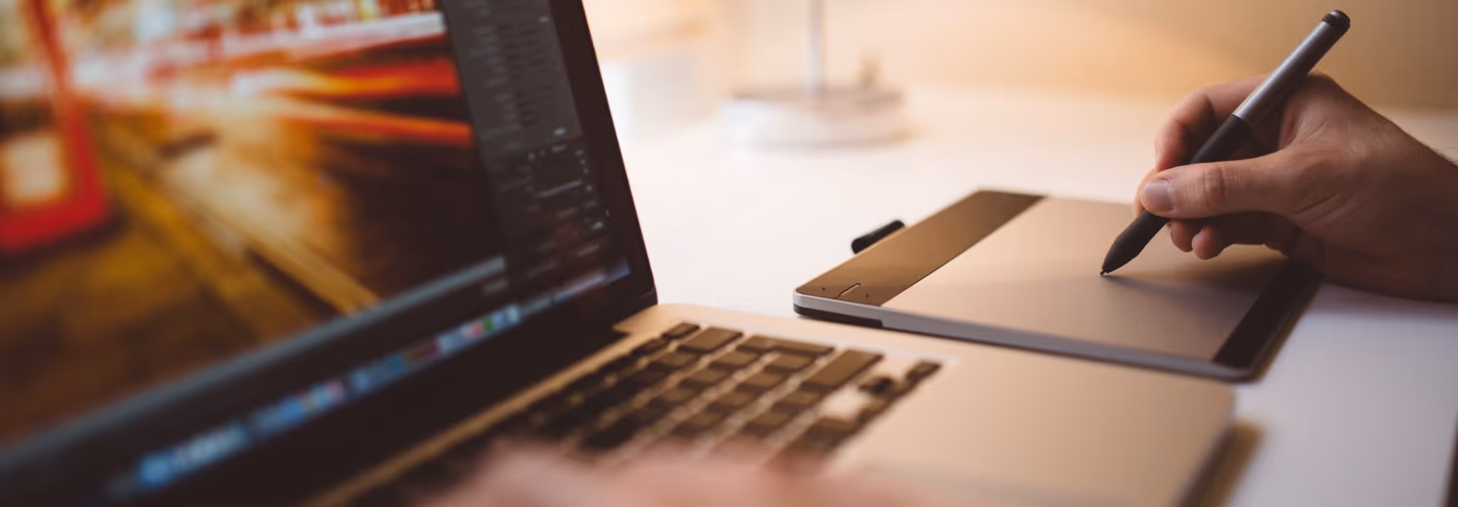 A young woman working in a machine shop. She is looking directly towards the camera, and is surrounded by men.