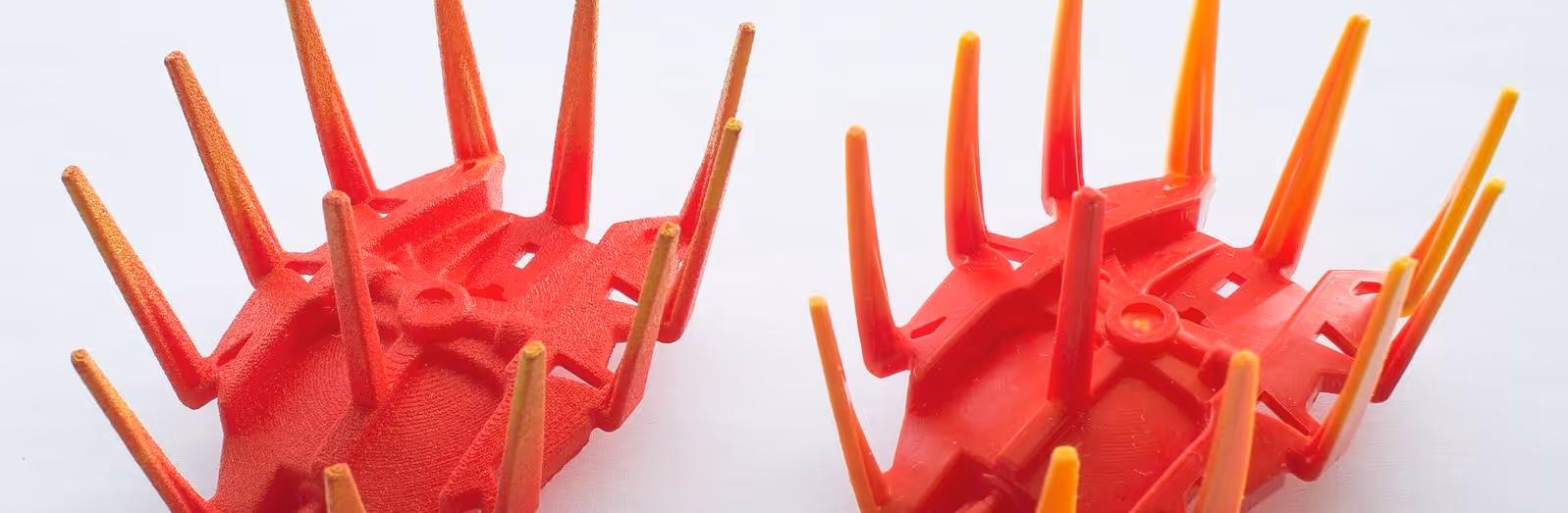 A young woman working in a machine shop. She is looking directly towards the camera, and is surrounded by men.