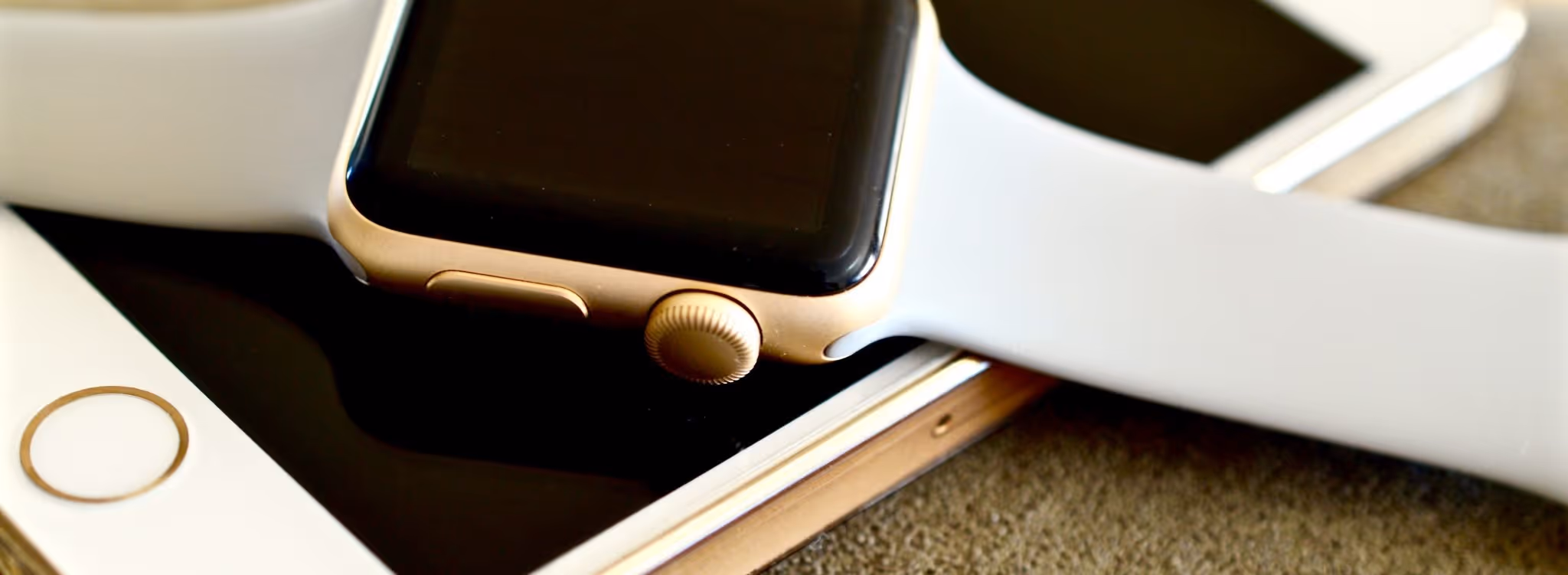A young woman working in a machine shop. She is looking directly towards the camera, and is surrounded by men.