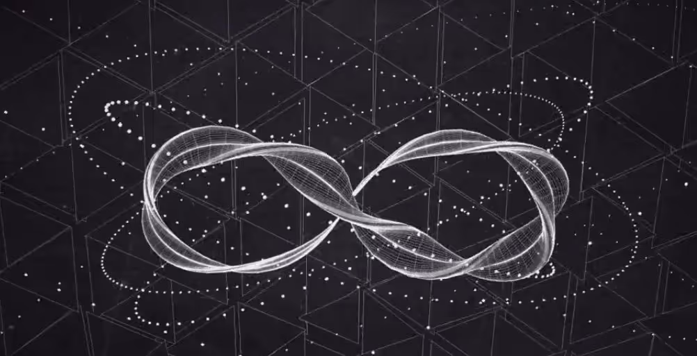 A young woman working in a machine shop. She is looking directly towards the camera, and is surrounded by men.