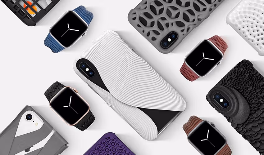 A young woman working in a machine shop. She is looking directly towards the camera, and is surrounded by men.