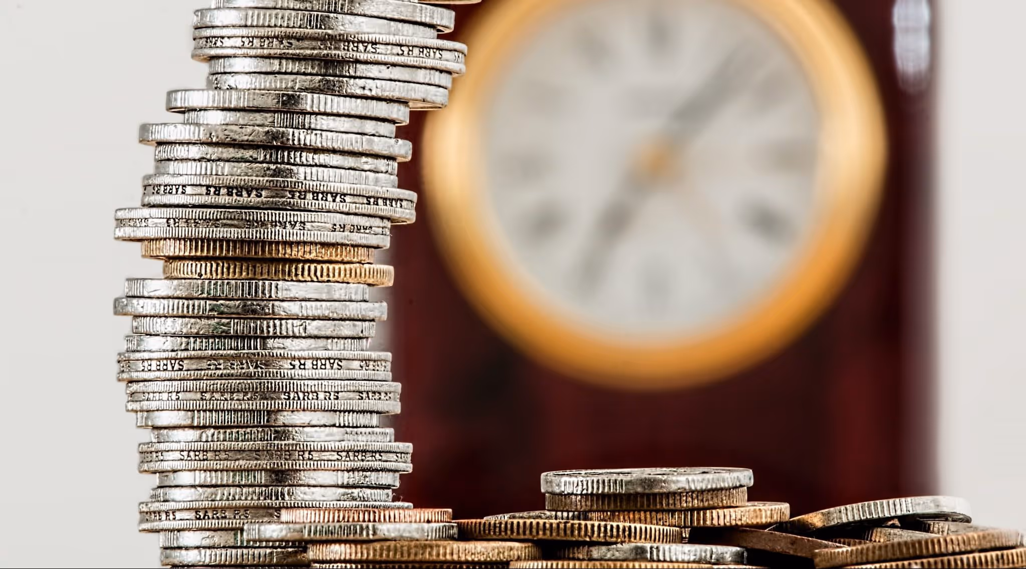 A young woman working in a machine shop. She is looking directly towards the camera, and is surrounded by men.