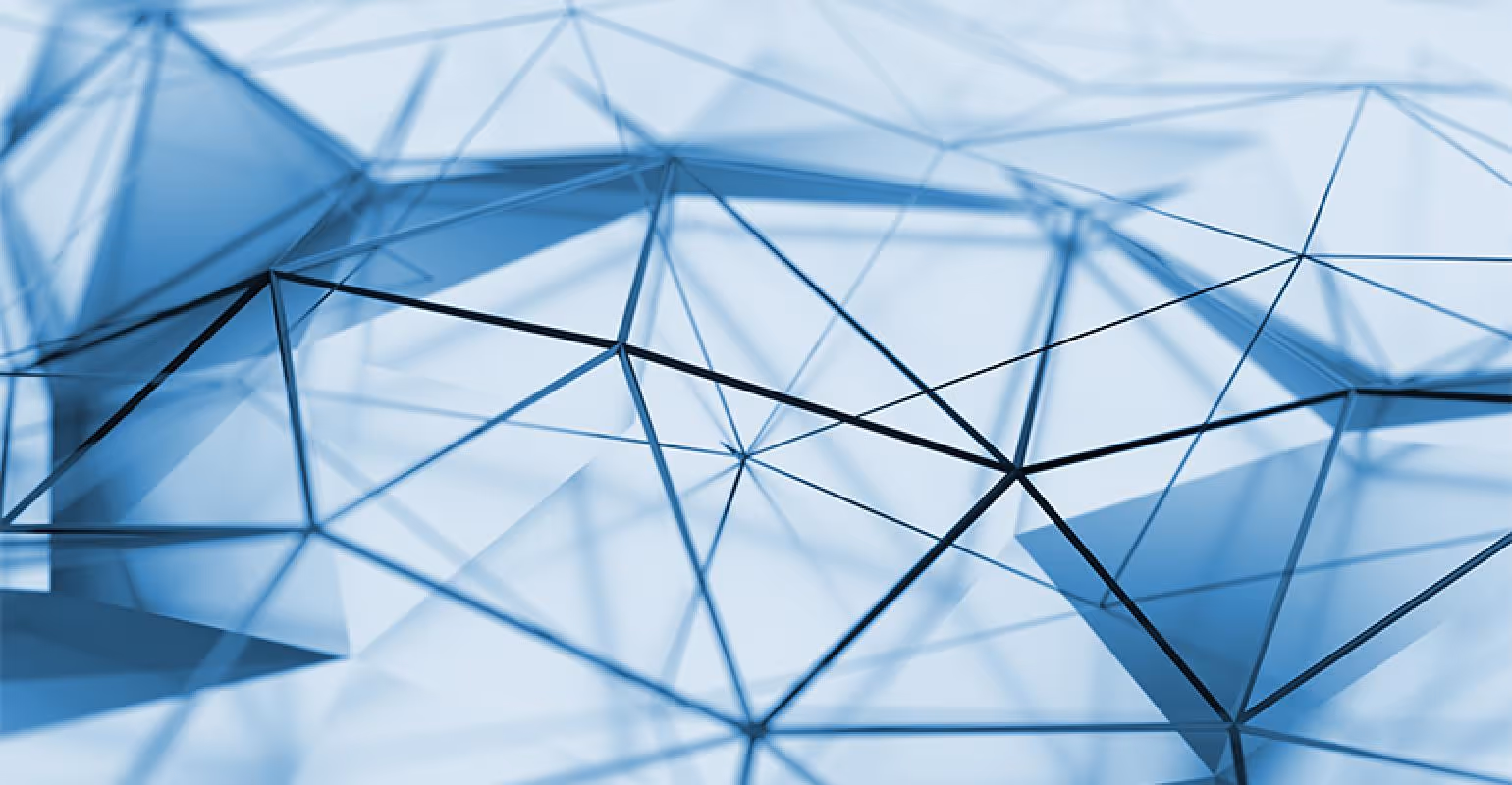 A young woman working in a machine shop. She is looking directly towards the camera, and is surrounded by men.