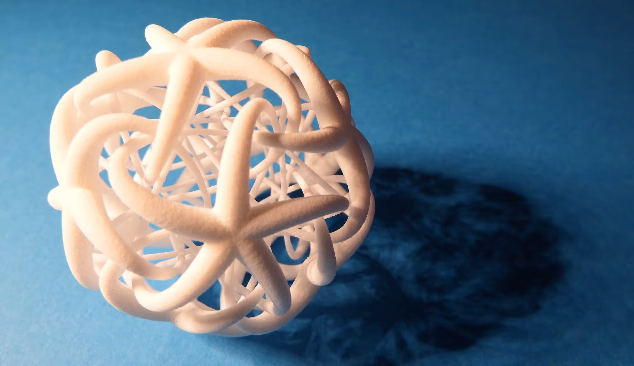 A young woman working in a machine shop. She is looking directly towards the camera, and is surrounded by men.