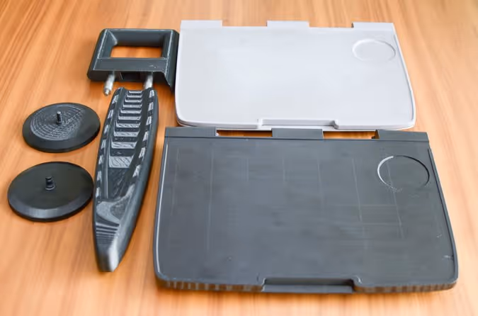 FDM 3D Printed Parts from left to right Electrical Connection Covers Grab Handle Arm Rest and Seat Back Table Photo Business Wire