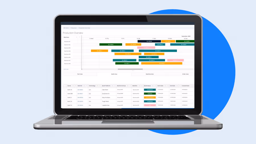 A young woman working in a machine shop. She is looking directly towards the camera, and is surrounded by men.