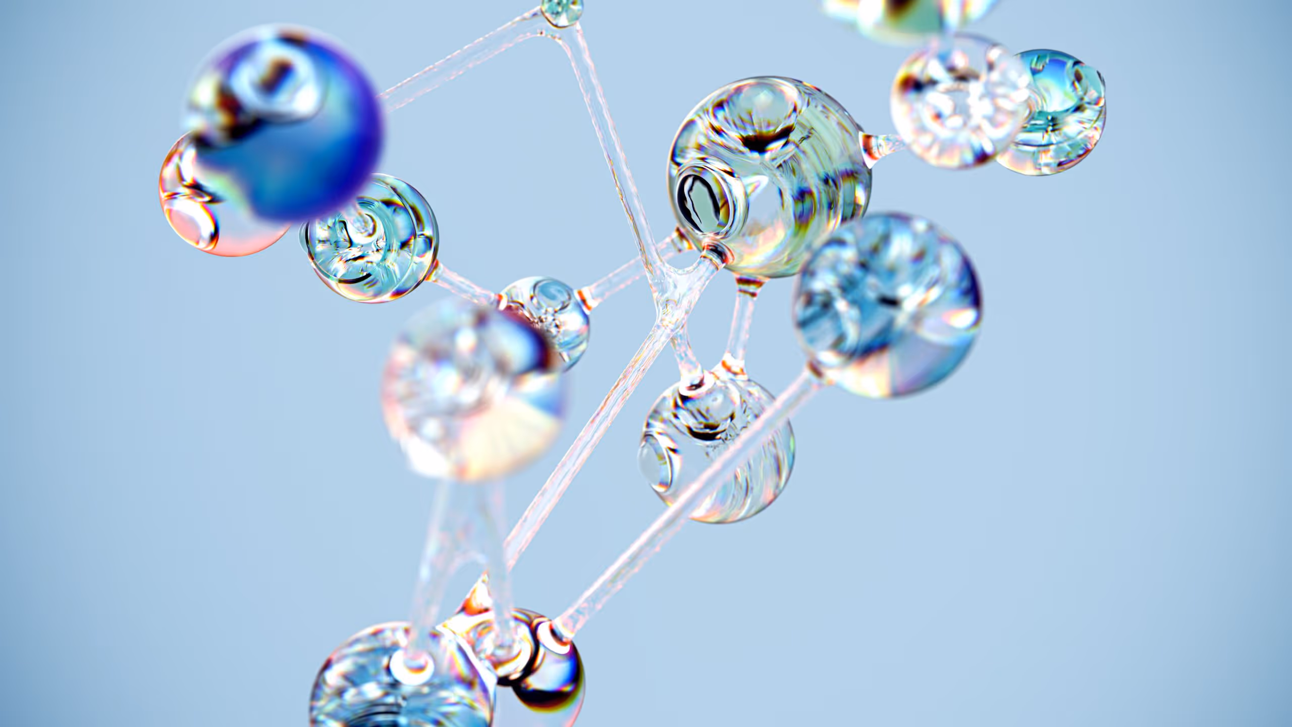 A young woman working in a machine shop. She is looking directly towards the camera, and is surrounded by men.