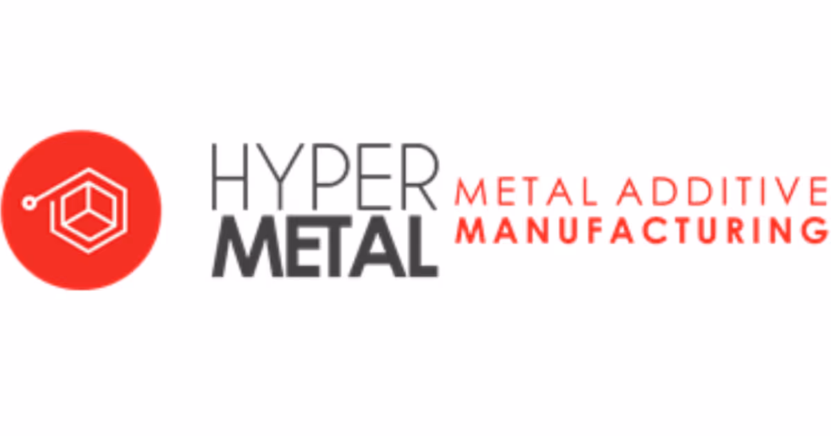 A young woman working in a machine shop. She is looking directly towards the camera, and is surrounded by men.