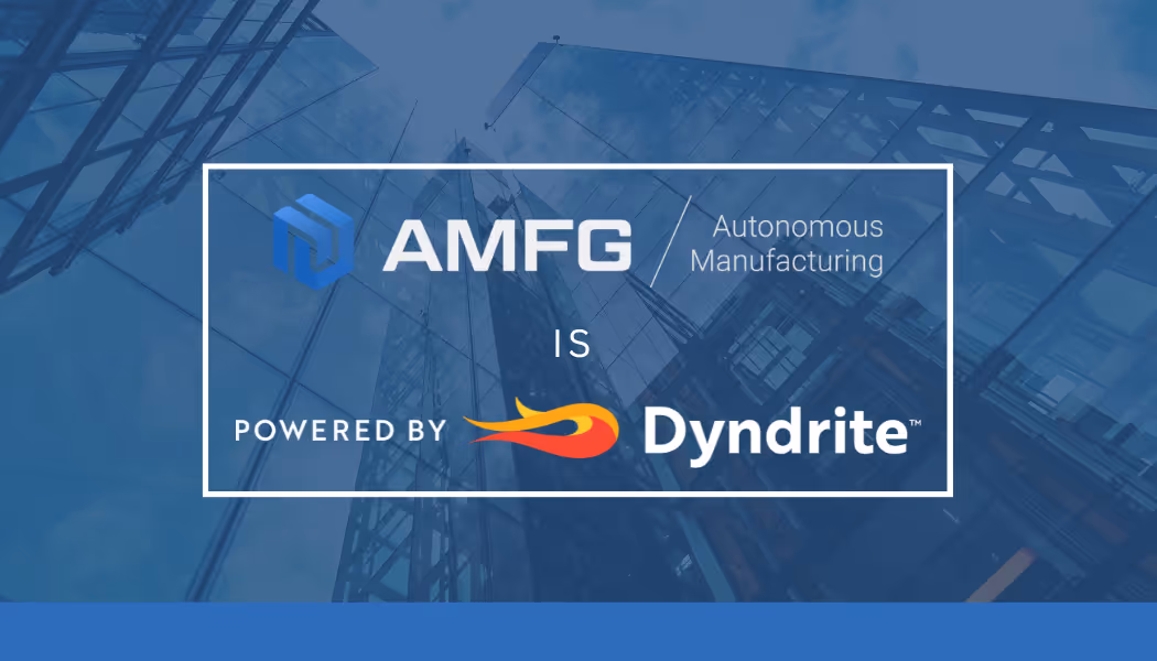 A young woman working in a machine shop. She is looking directly towards the camera, and is surrounded by men.