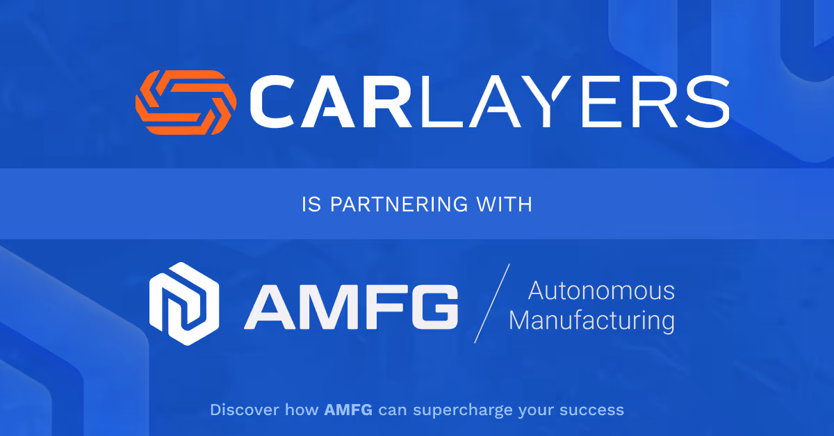 A young woman working in a machine shop. She is looking directly towards the camera, and is surrounded by men.