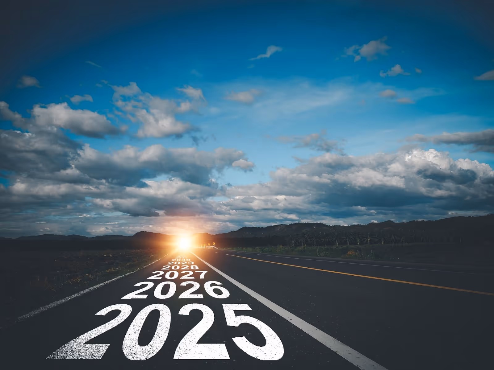 A highway, along it reads "2025, 2026, 2027" and it stretches into the sunset