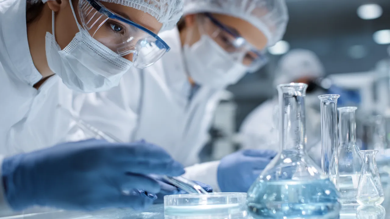 Scientists handling chemistry experiments to support small molecule development and scale-up for IND success.