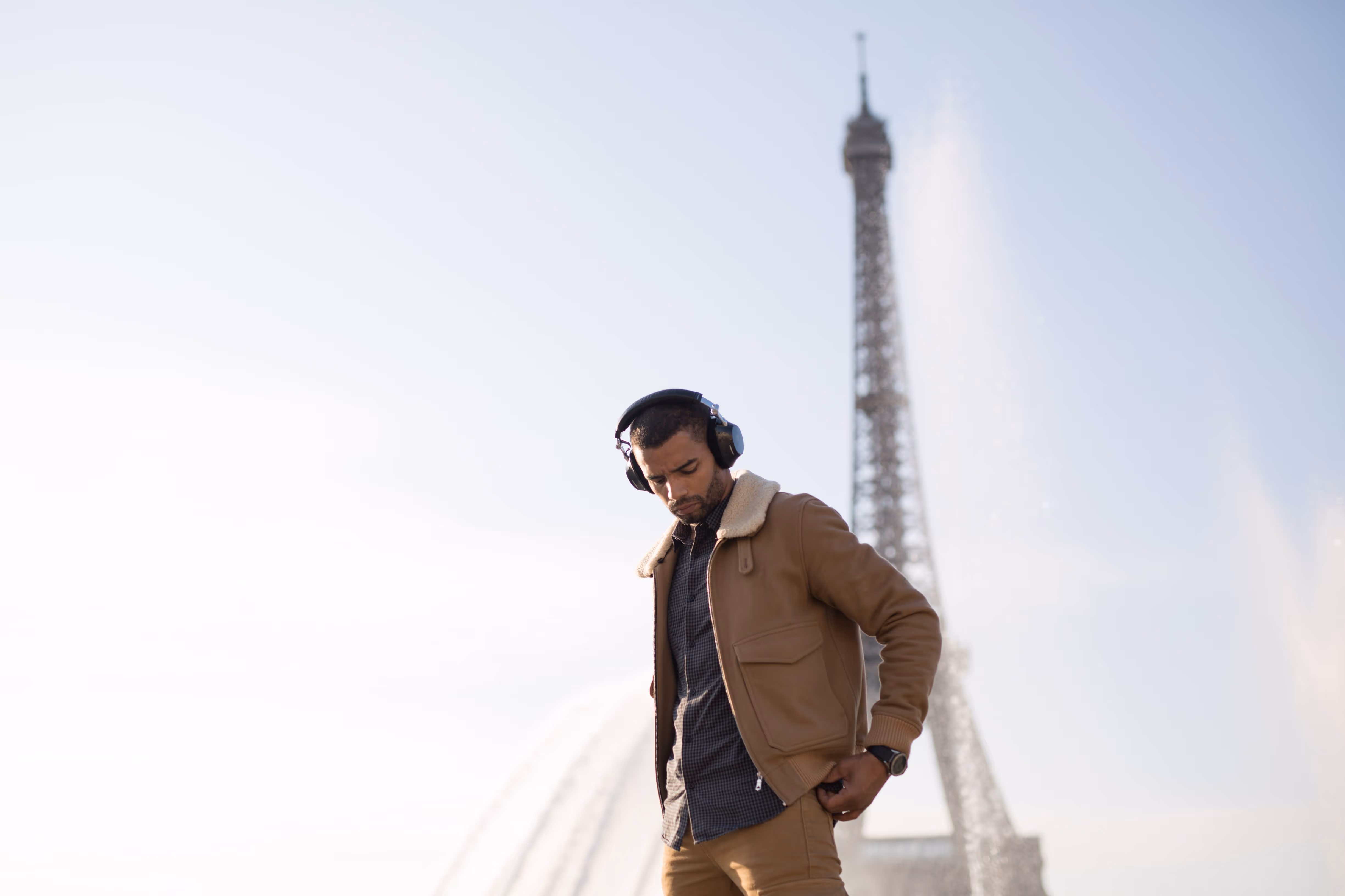 Performer wearing headphones near the Eiffel Tower in Paris for a L'Imagerie Films brand film production.

