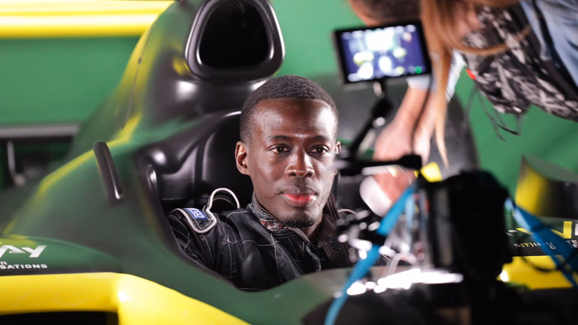 Race car driver seated in a cockpit during a L'Imagerie Films brand film production.
