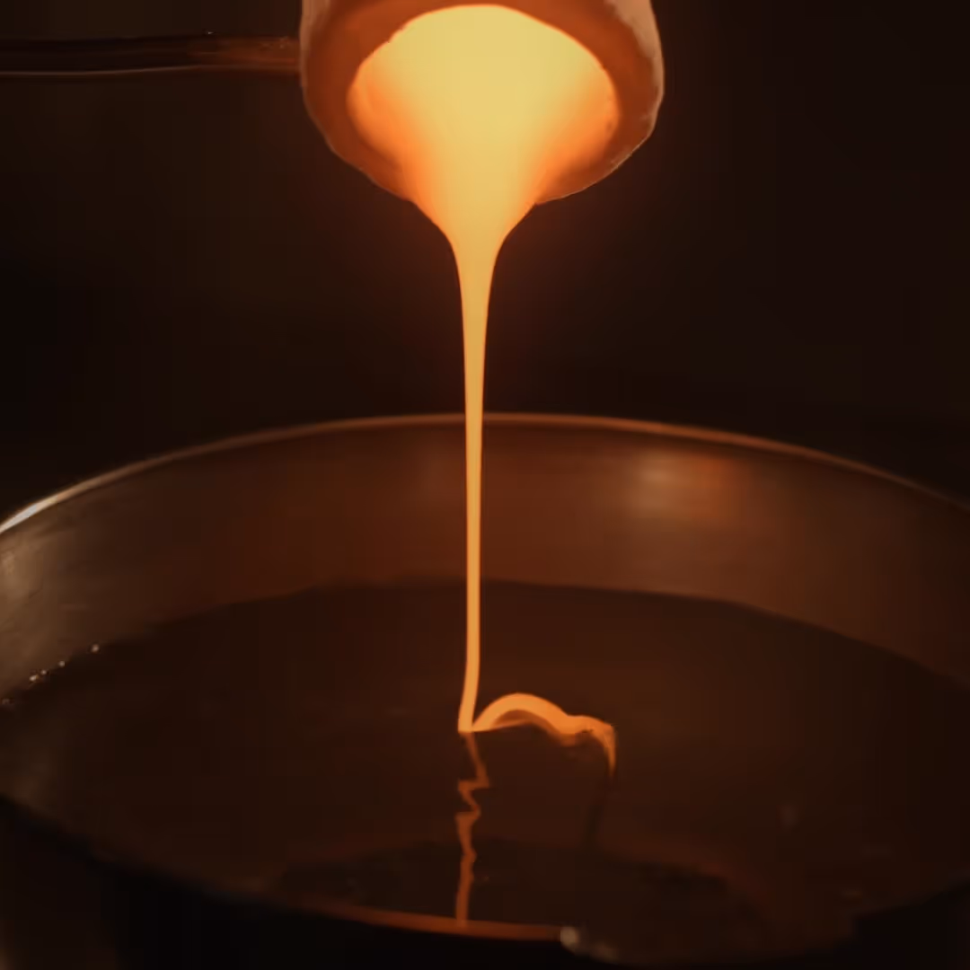 Glowing molten material poured into a mold during a cinematic L'Imagerie Films brand film production.
