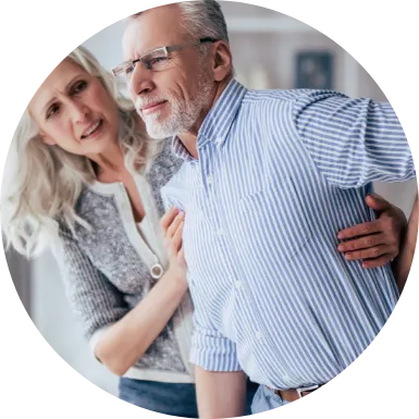 woman helping man stand who has pain