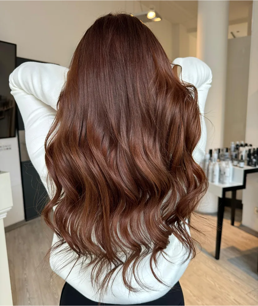 The back of a woman's head with red hair.