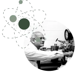 Scientist working with microscope, paired with atomic structure illustration representing material science