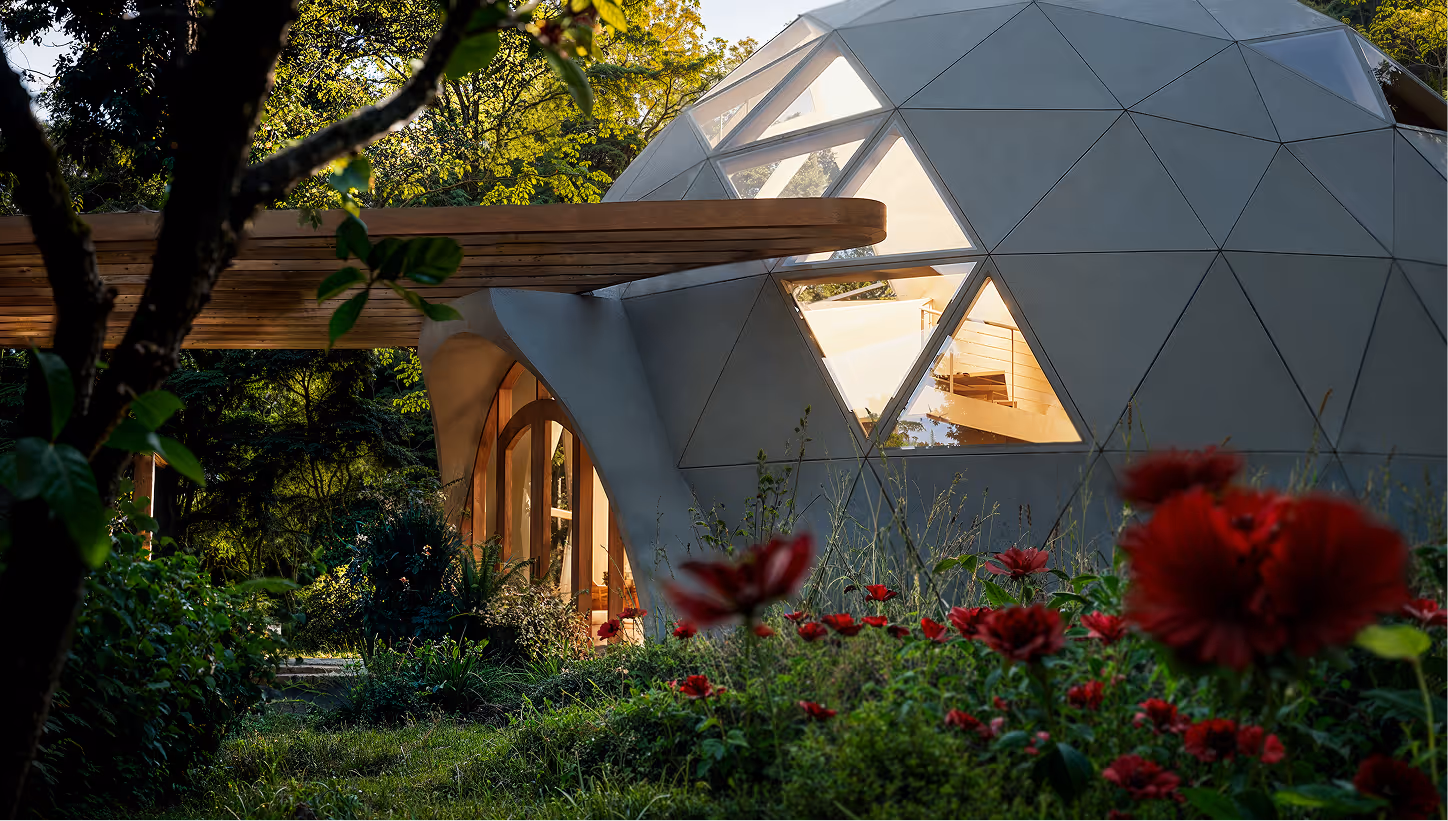A white dome shaped houses in a forest.