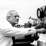 Scientist working with microscope equipment in a laboratory, black and white photograph