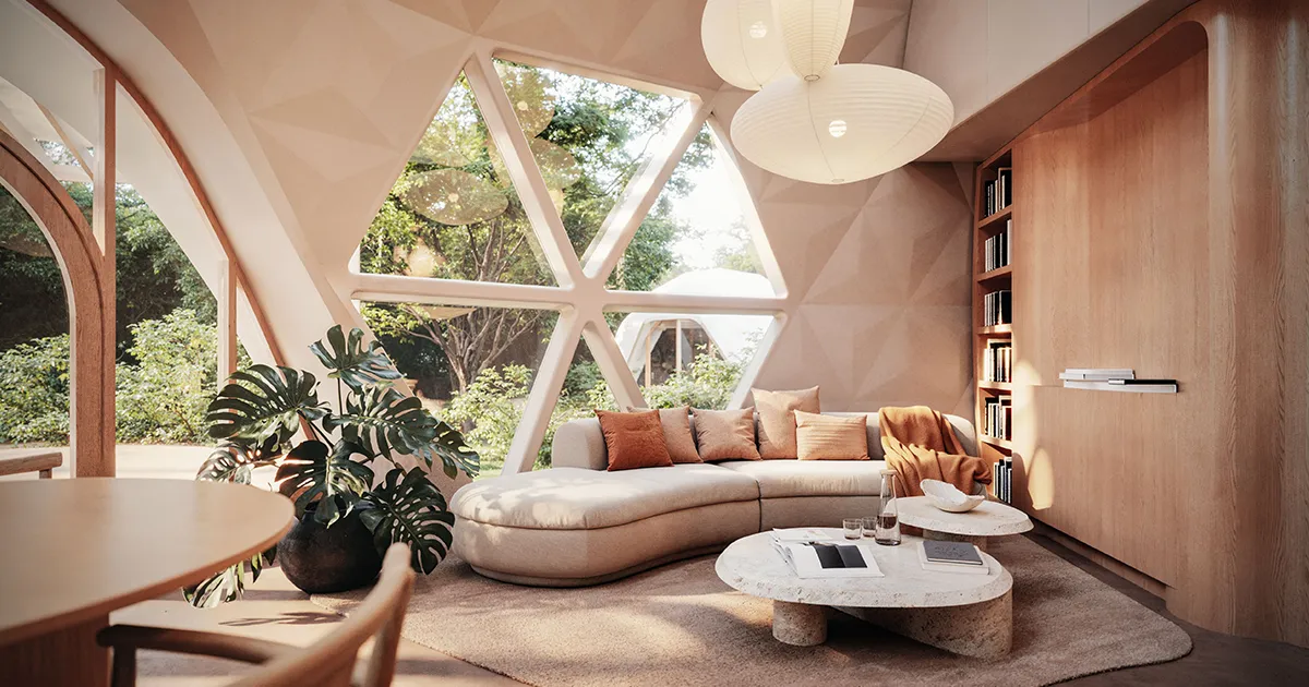 Cozy living room inside a Geoship dome with curved sectional sofa, triangular windows overlooking greenery, and built-in bookshelf