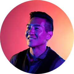 Smiling Asian man photographed with colorful gradient lighting