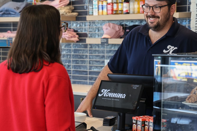 A guest paying with Cluster Payments at the counter