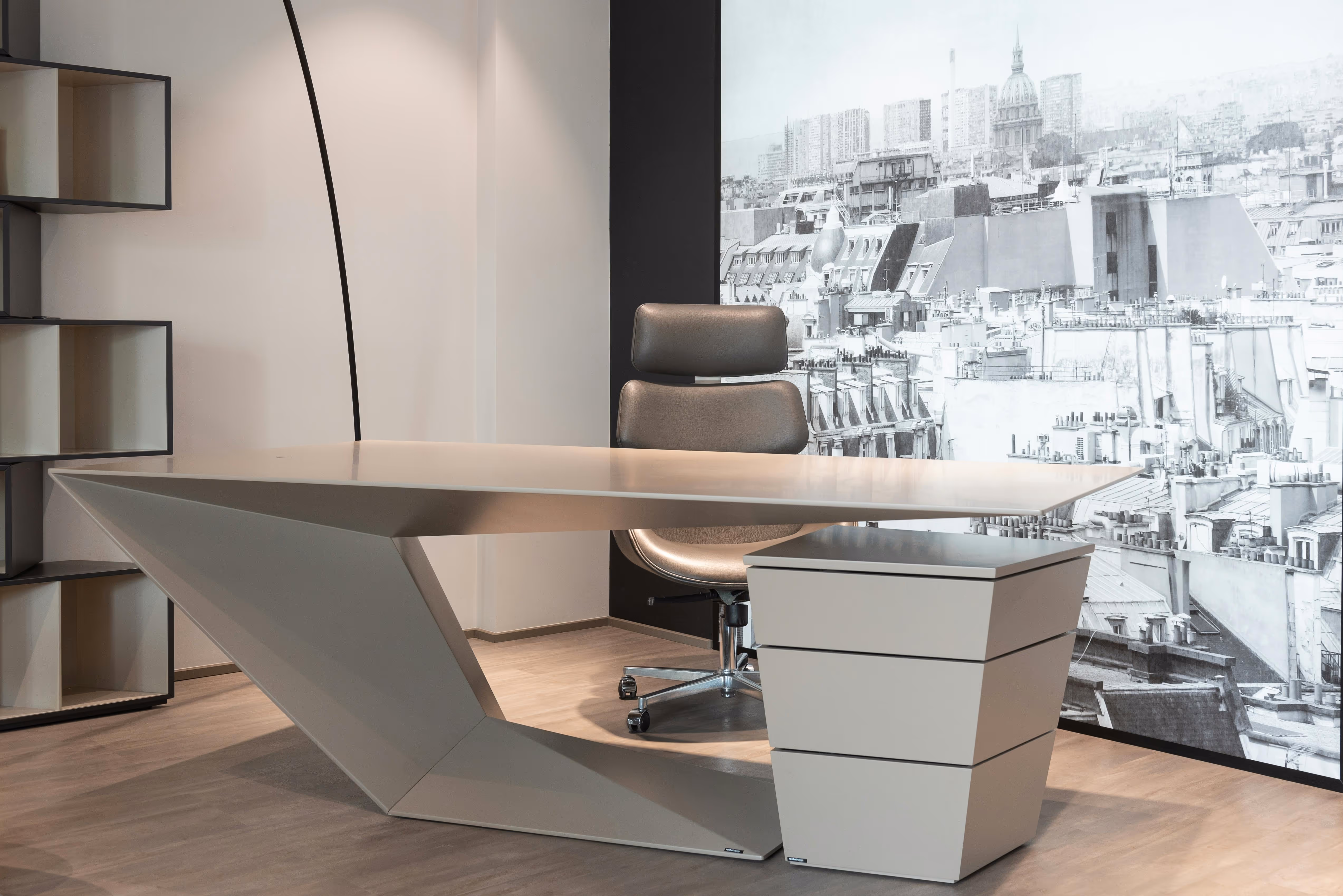 Modern office desk with angular design and leather chair