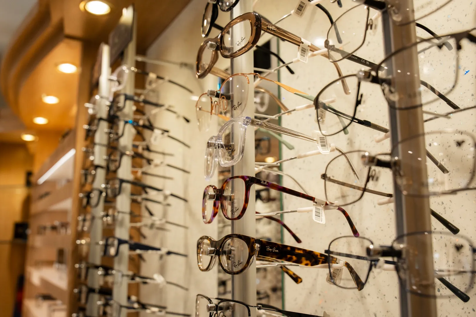 Eyeglasses display wall in optical store with various frame styles