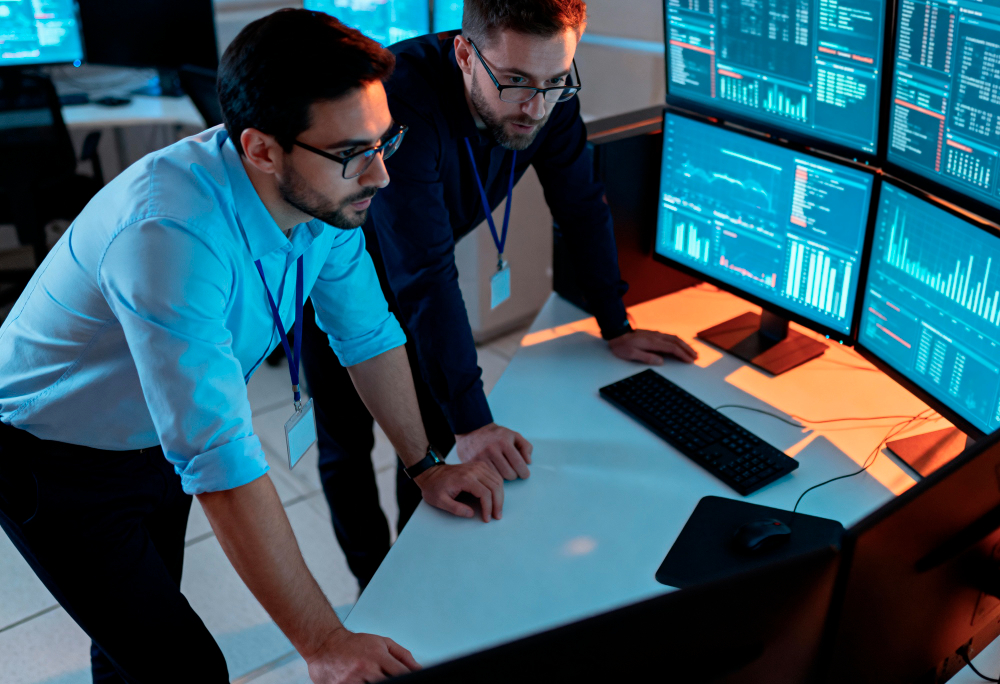 Business owner reviewing computers, networks, and technology systems to assess whether their IT infrastructure is ready for growth.