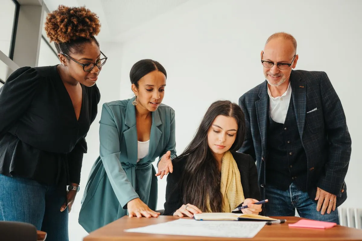 Three women looking at a laptop screen