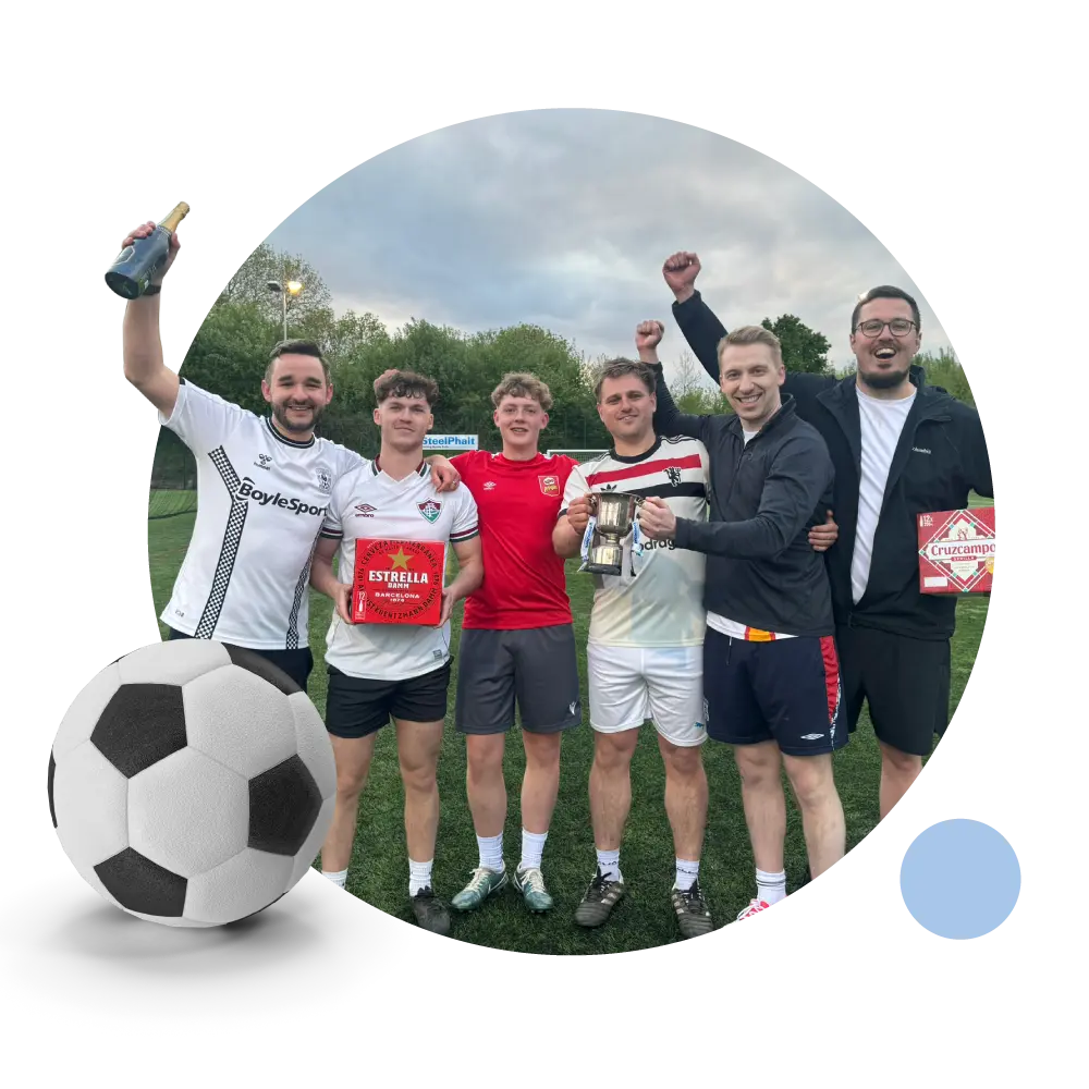 People celebrating a competition win with a pop out picture of a football