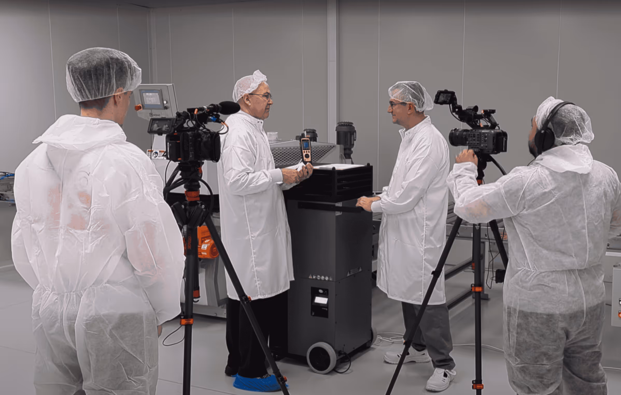 REAS Group filming in cleanroom environment with laboratory team
