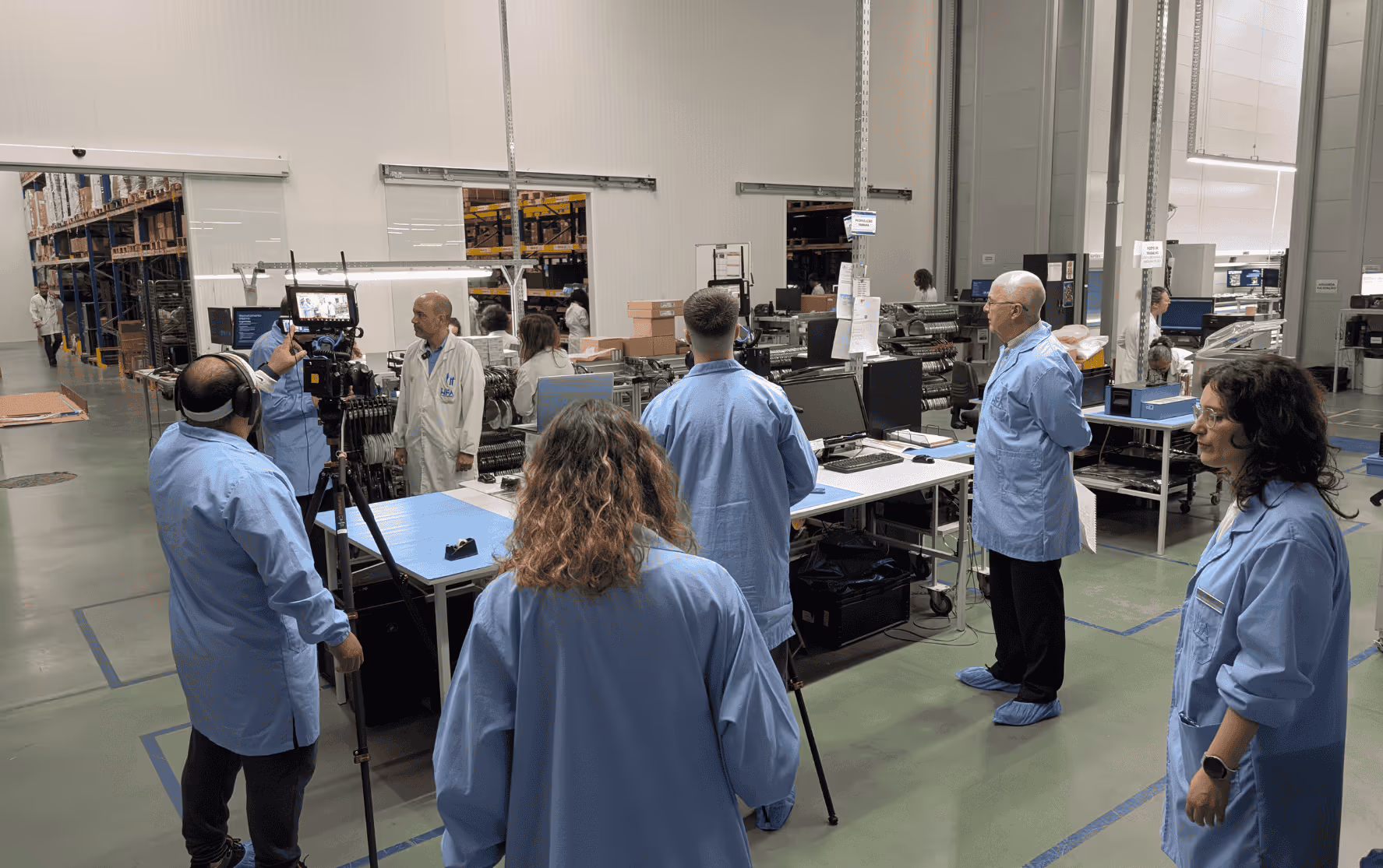 REAS Group video production team filming inside a manufacturing facility