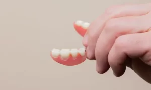 hand holding a denture