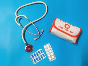 First aid emergency dental kit on blue table