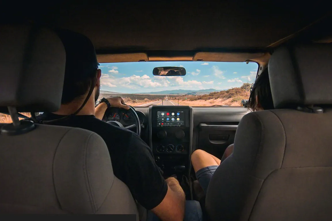 Family driving and using a aftermarket Sony screen displaying Apple Carplay