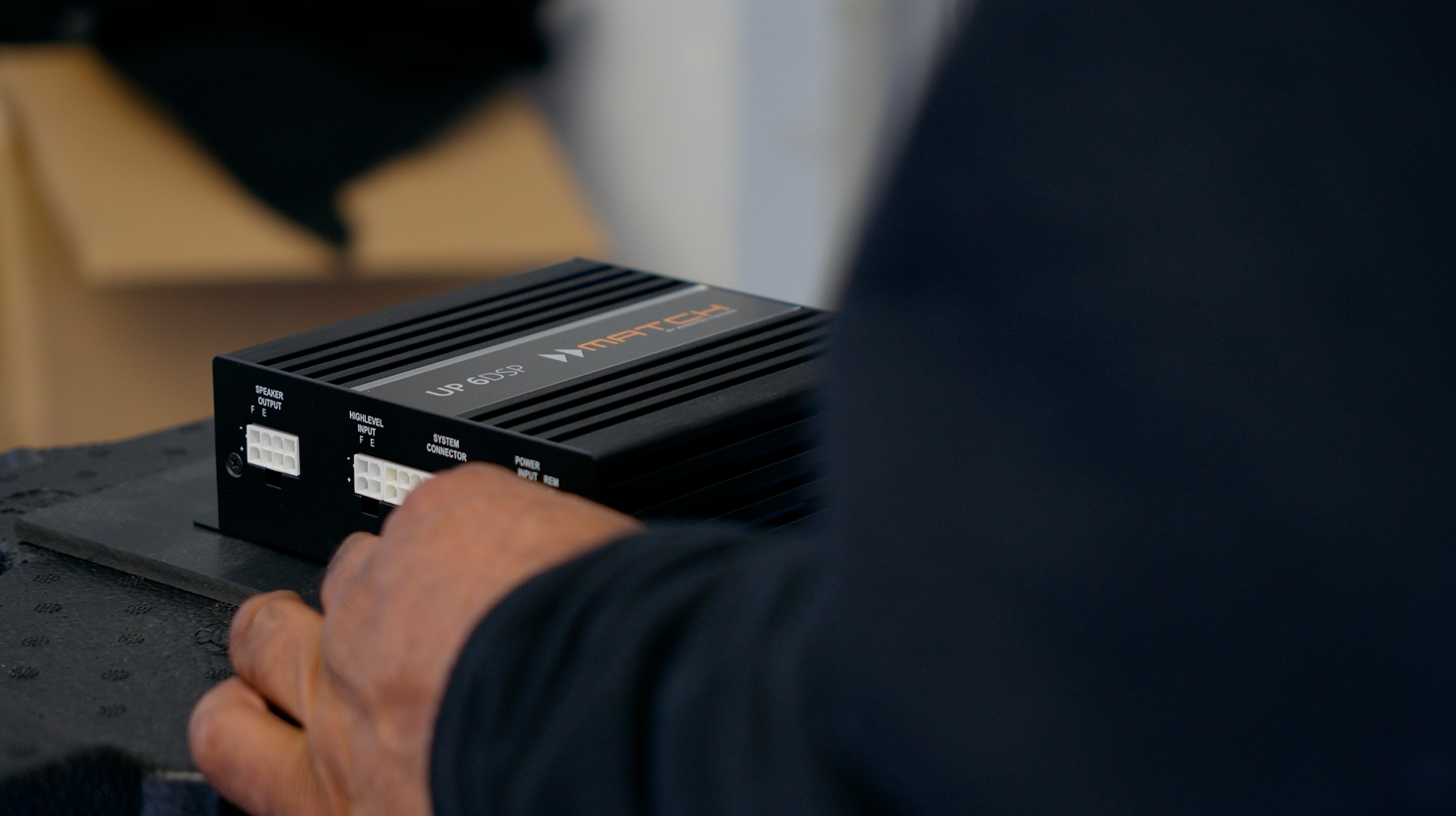 Advanced Mobile Entertainment technician mounting a Match UP 6DSP