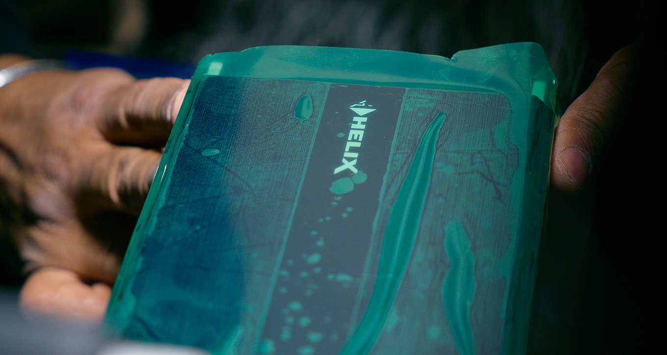 Close-up of hands holding a Helix DSP.