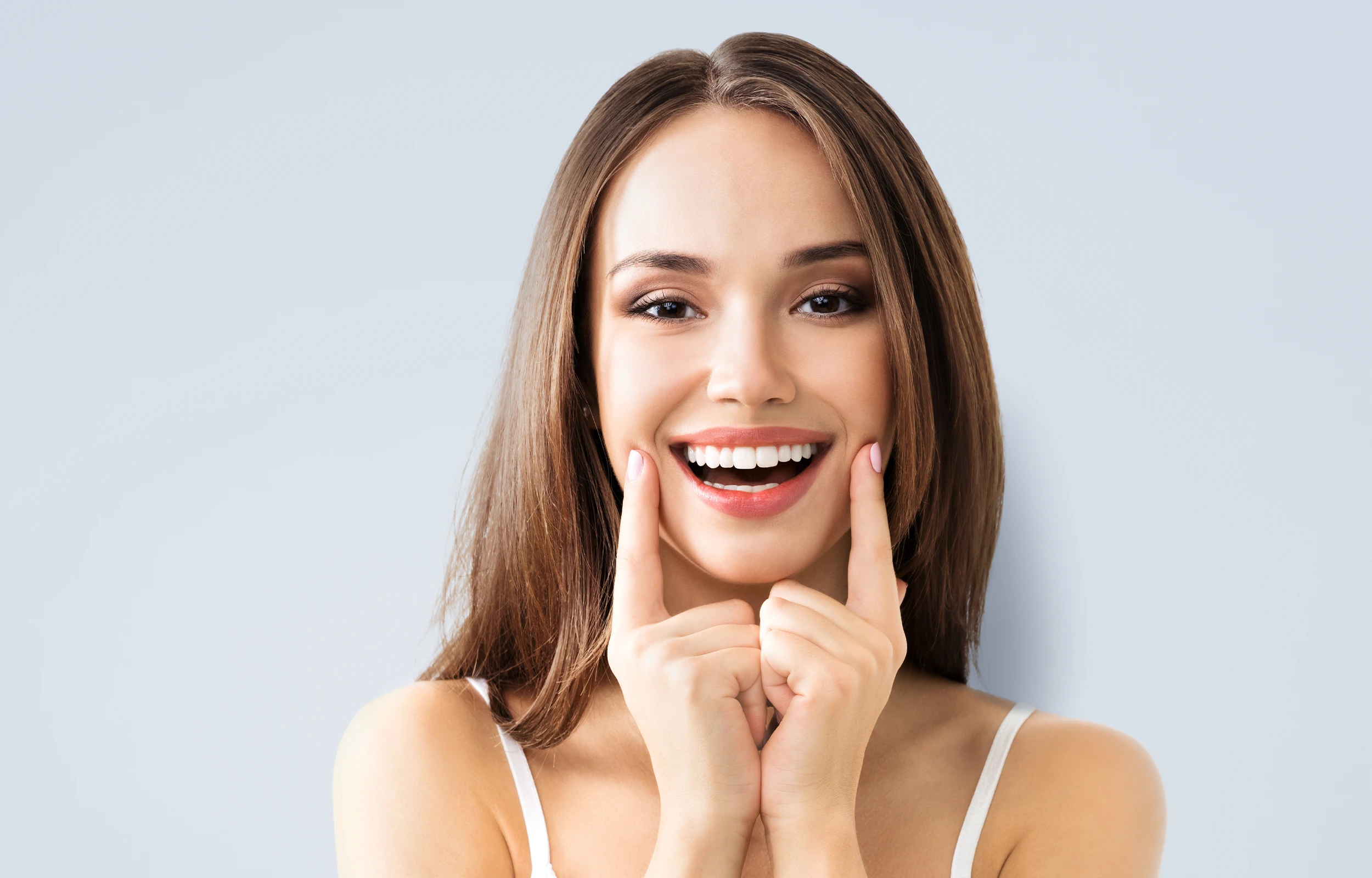 A woman smiling, showing her teeth