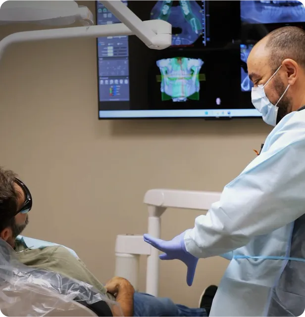 A man sitting in a chair with a medical mask on.