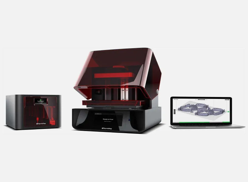 A red and black computer tower with a laptop next to it.