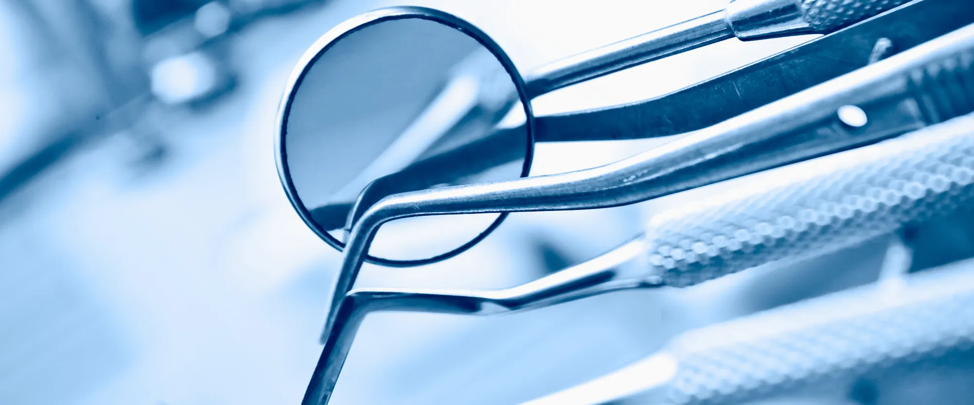 A close up of a pair of scissors and a mirror.