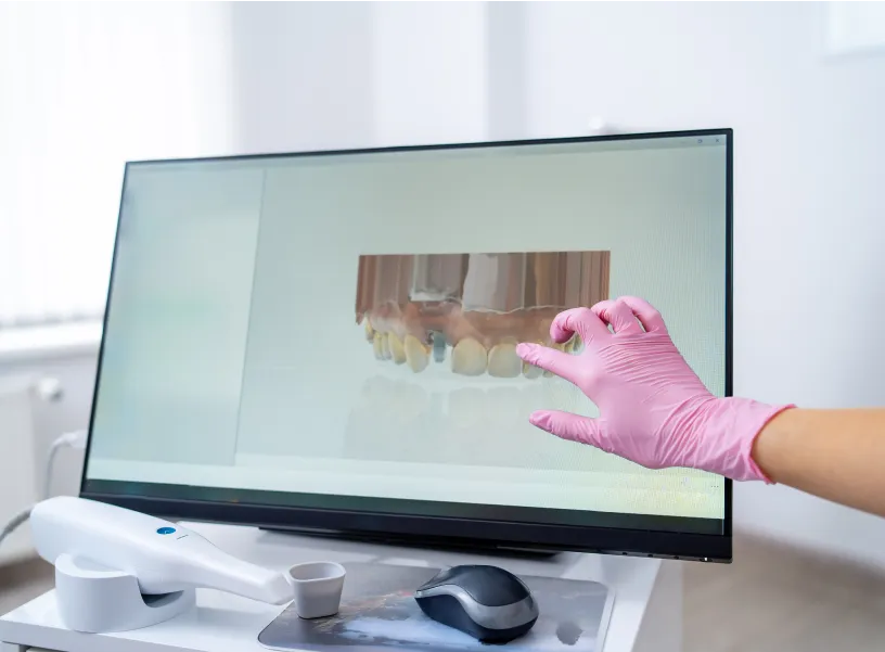 A person in pink gloves is pointing at a screen.