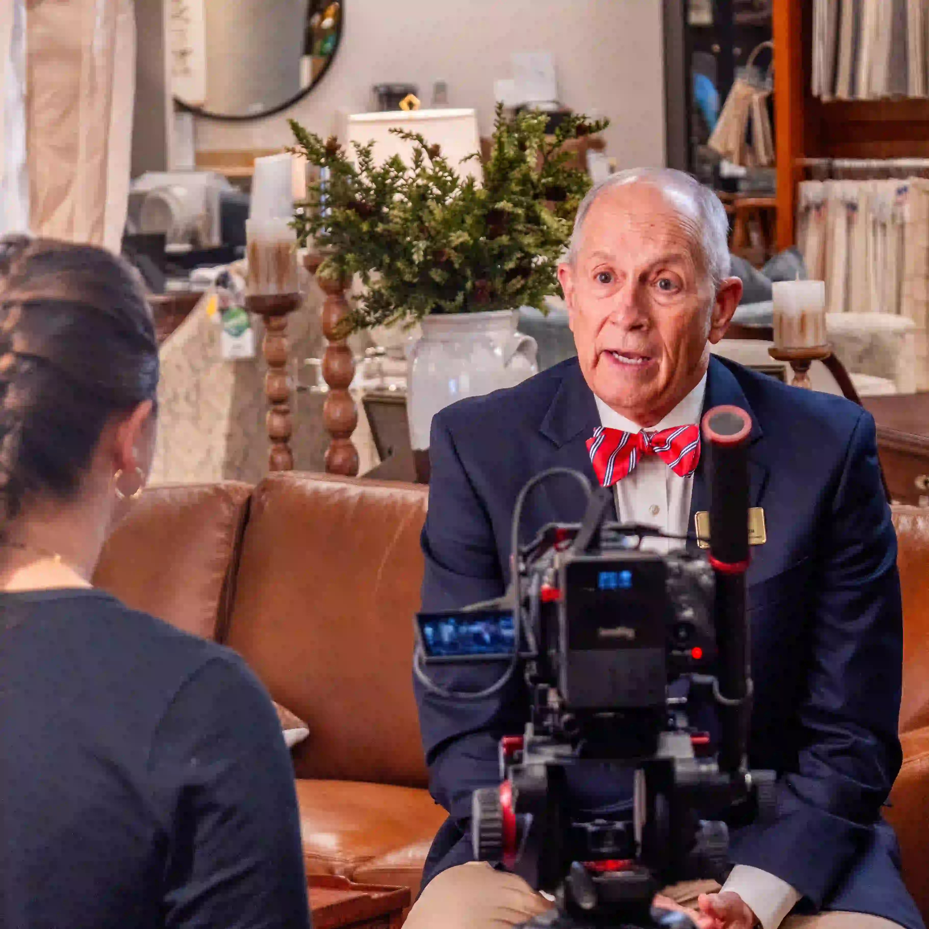 Interview setup with suited guest and cinema camera—Chesser Media corporate video.