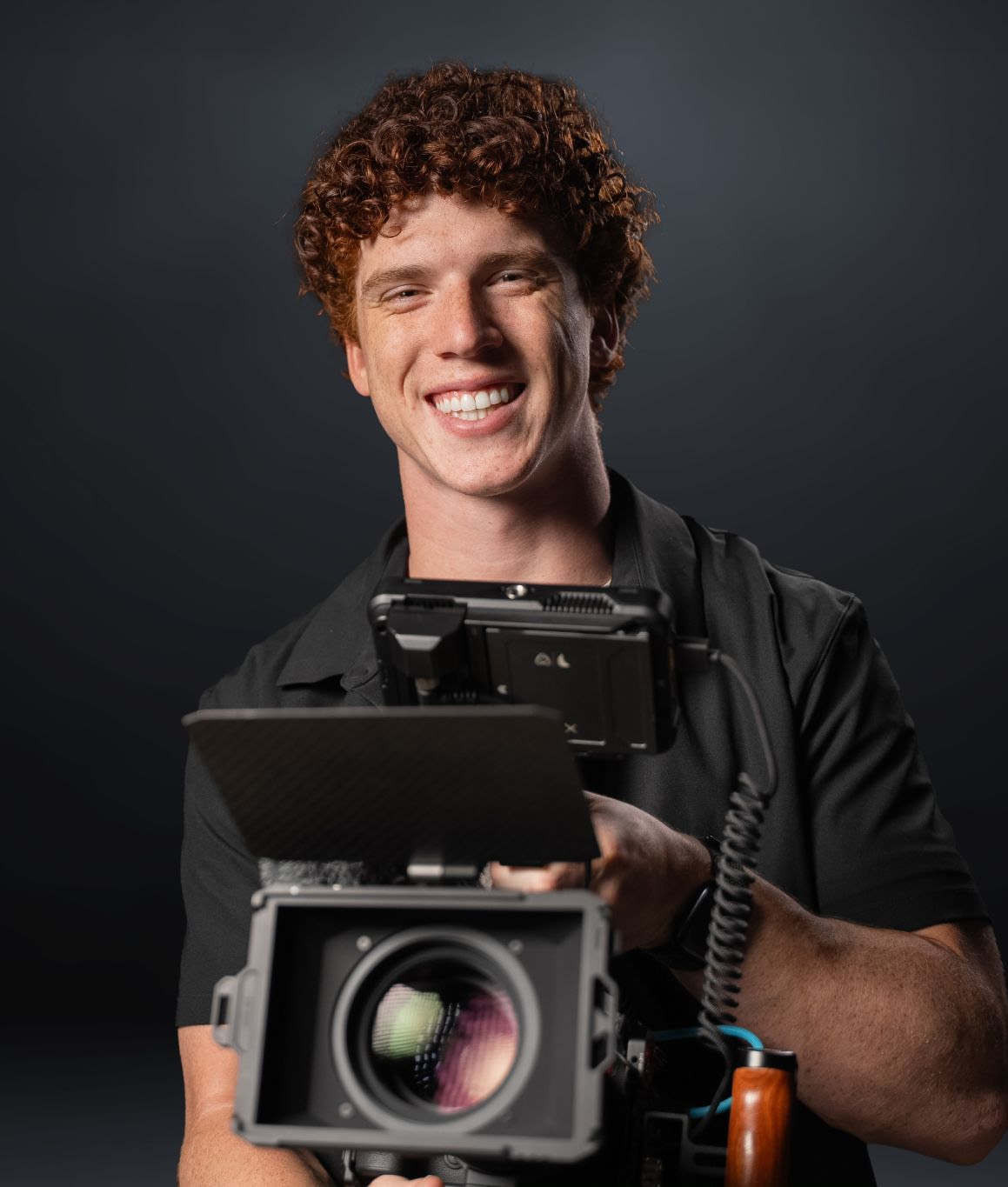 Cinematographer portrait holding cinema camera—Chesser Media crew member.