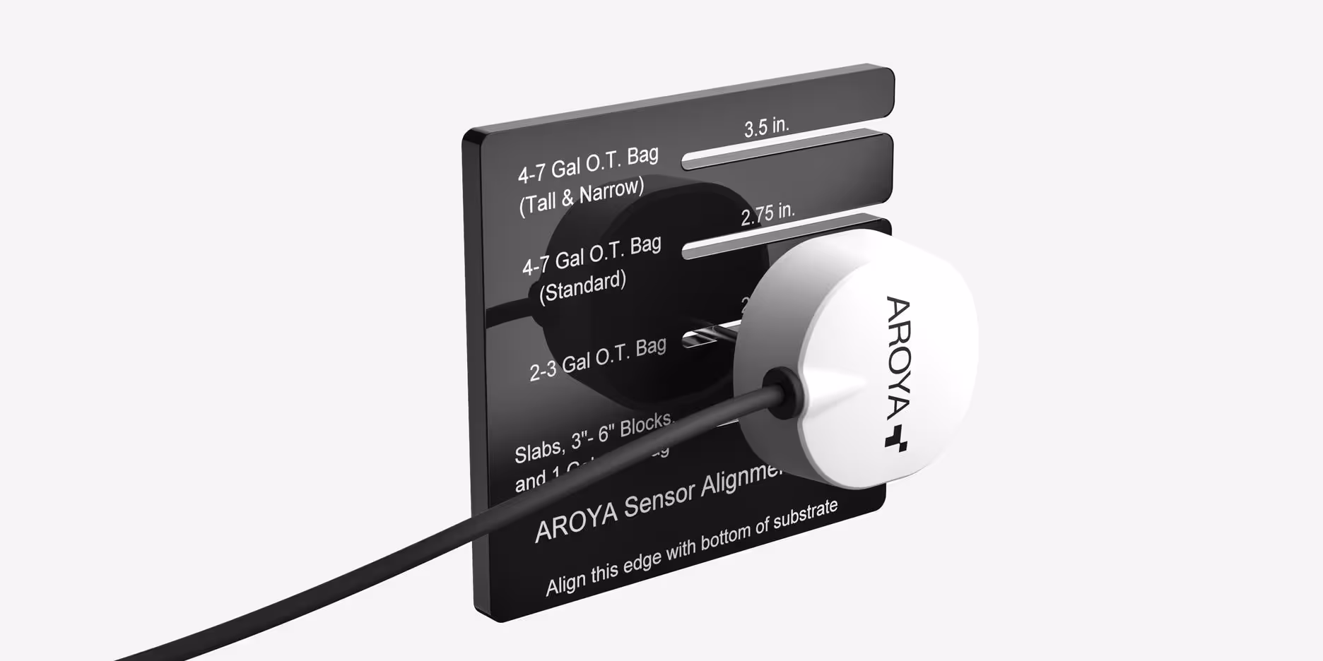 Close-up of AROYA alignment board marked with depth measurements for correct sensor placement in grow bags and blocks